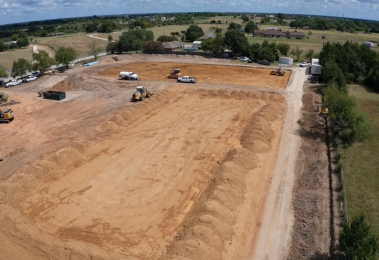 Aerial view of a large graded commercial site cut out of ranch land