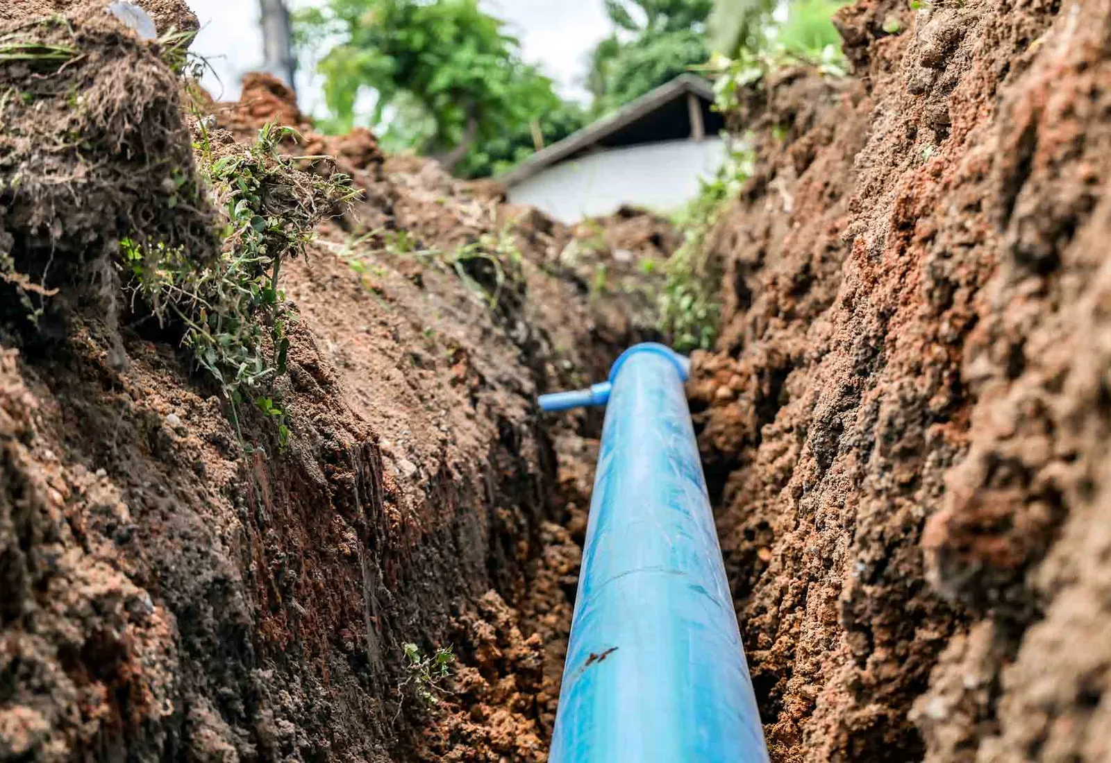 Water line set in an open trench on a bed of graded material